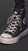 Detail of LYRIA's black high-top sneaker.